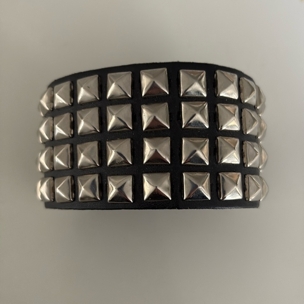 Studded wrist band black and silver tone